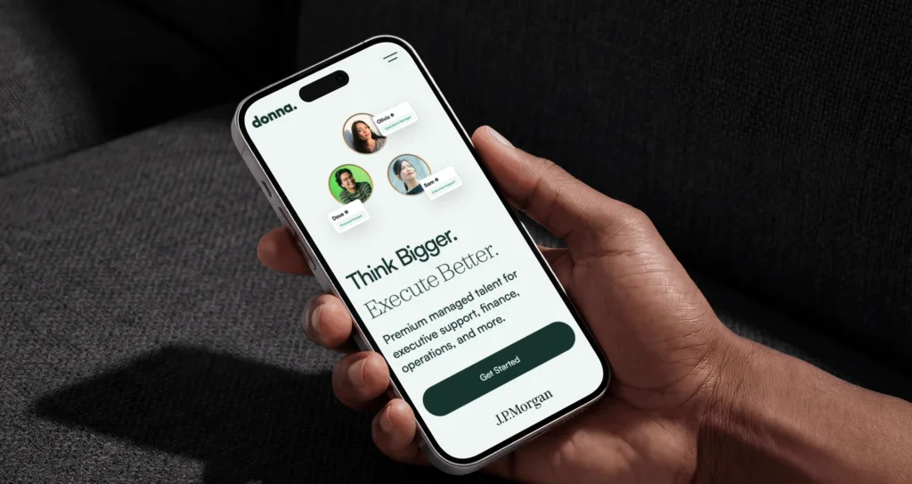 The Hire Donna website on an iPhone, its hero reading Think Bigger. Execute Better.