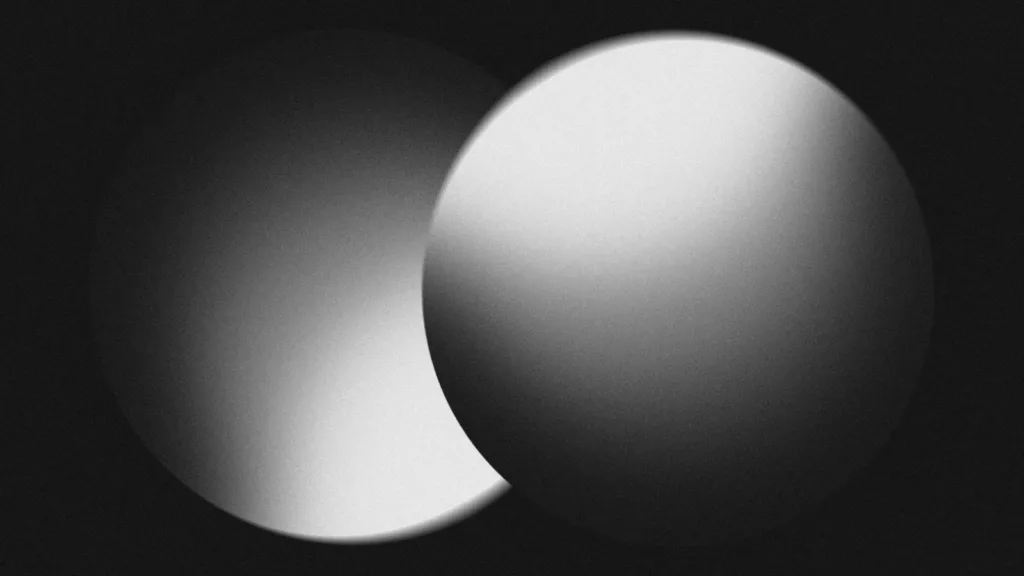 Two overlapping spheres in monochrome light and shadow