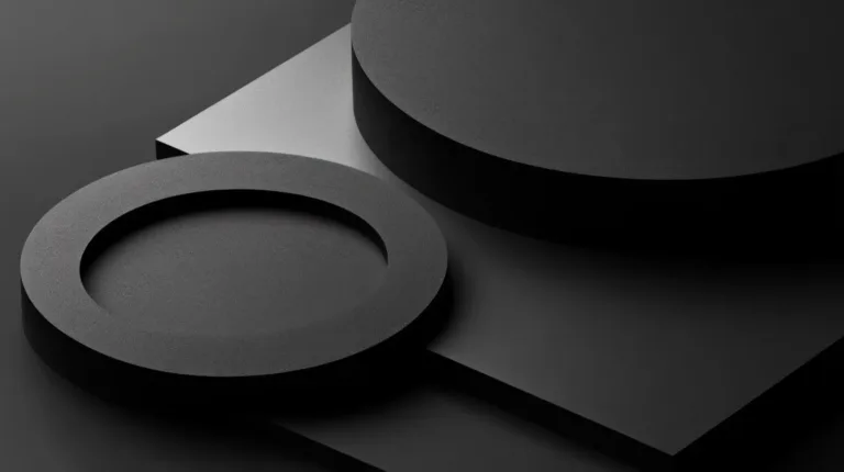 Dark grey geometric discs arranged in low light