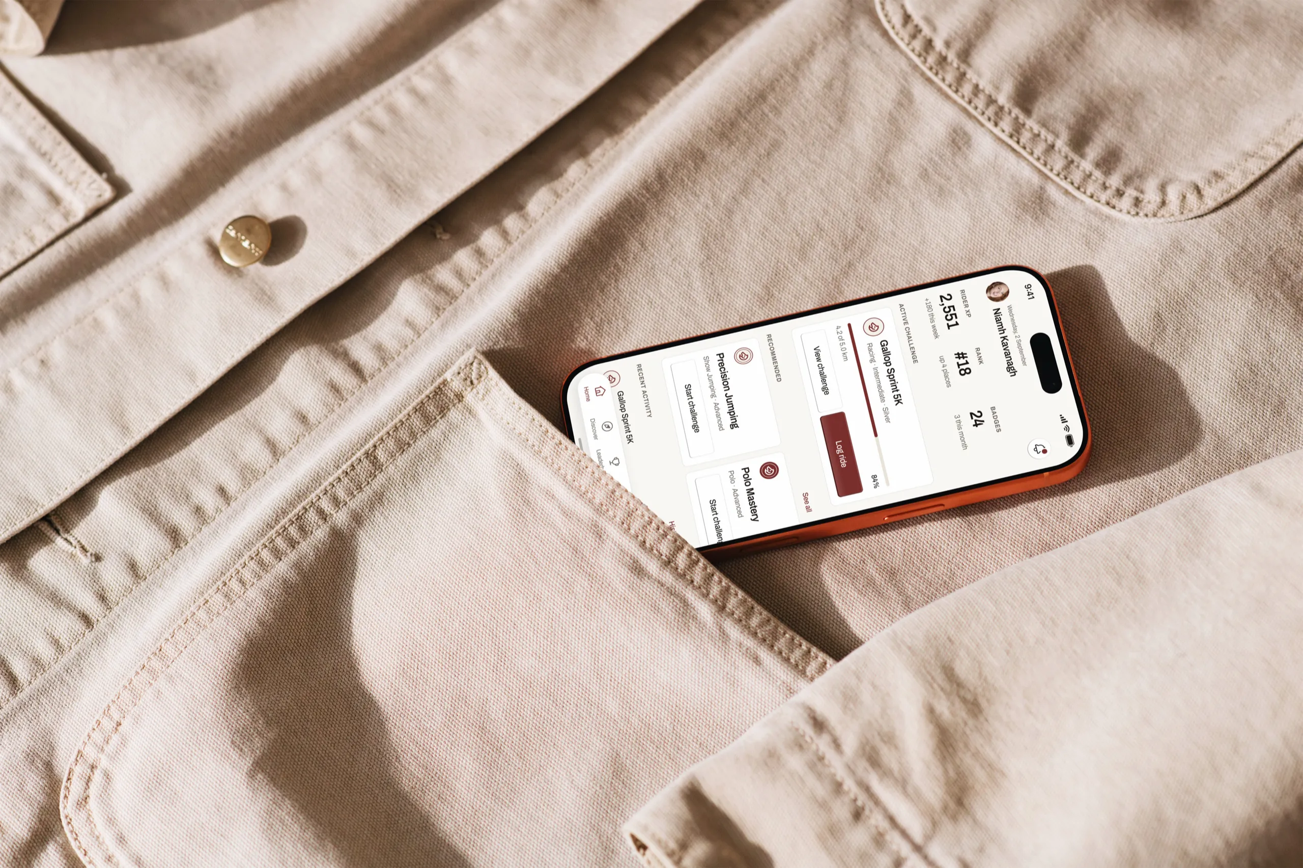 The Bridlepath home screen on an iPhone in the pocket of a canvas jacket