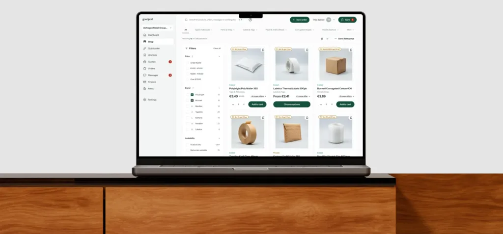 The goodport catalogue on a MacBook on a wooden sideboard