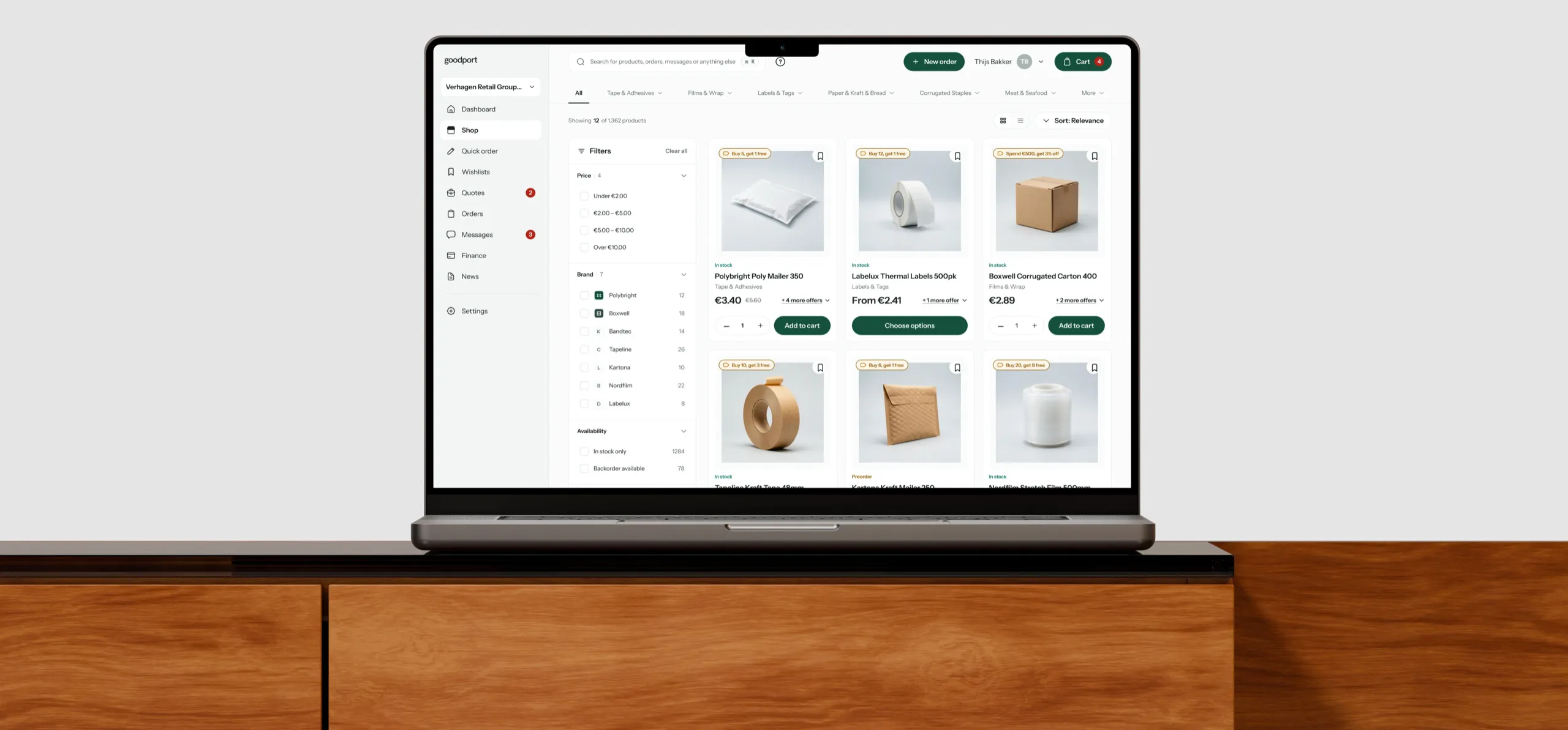 The goodport catalogue on a MacBook on a wooden sideboard
