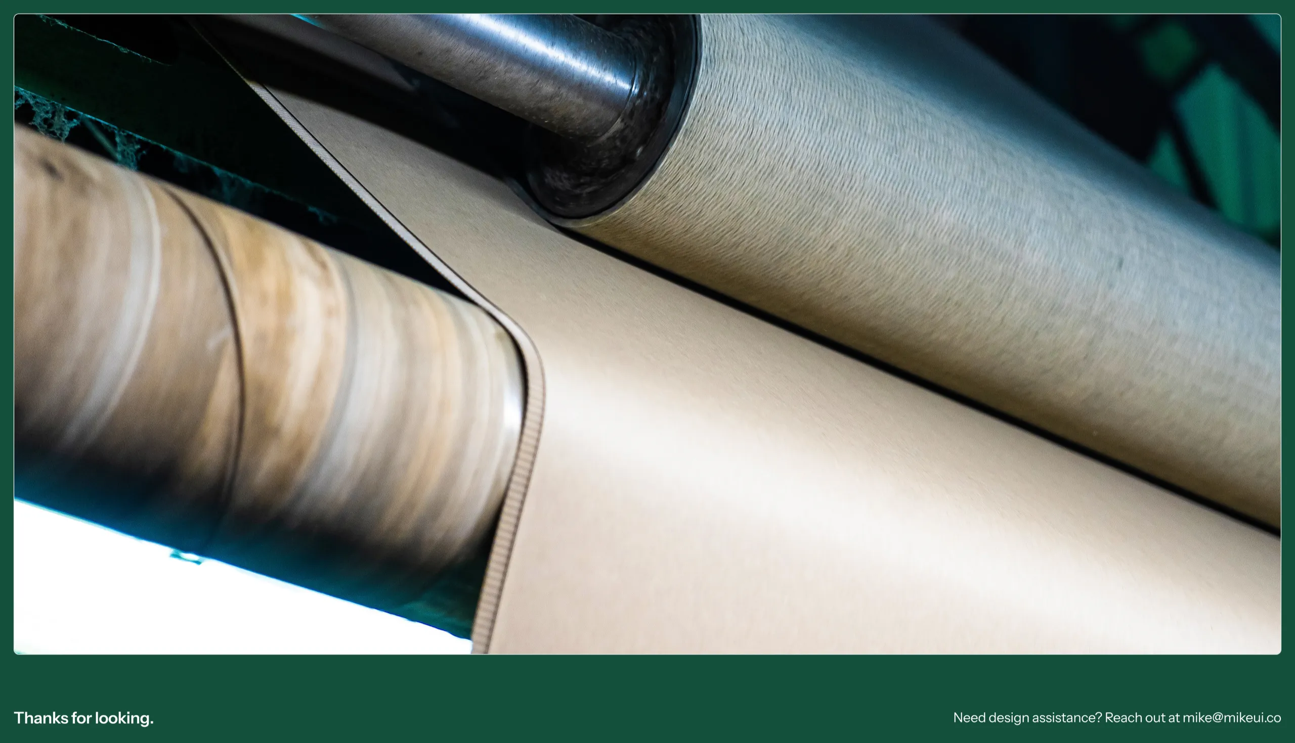 Kraft paper running through production rollers, closing the case study with Mike's contact email
