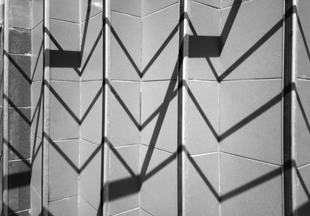 Black and white zigzag shadows falling across a stair wall