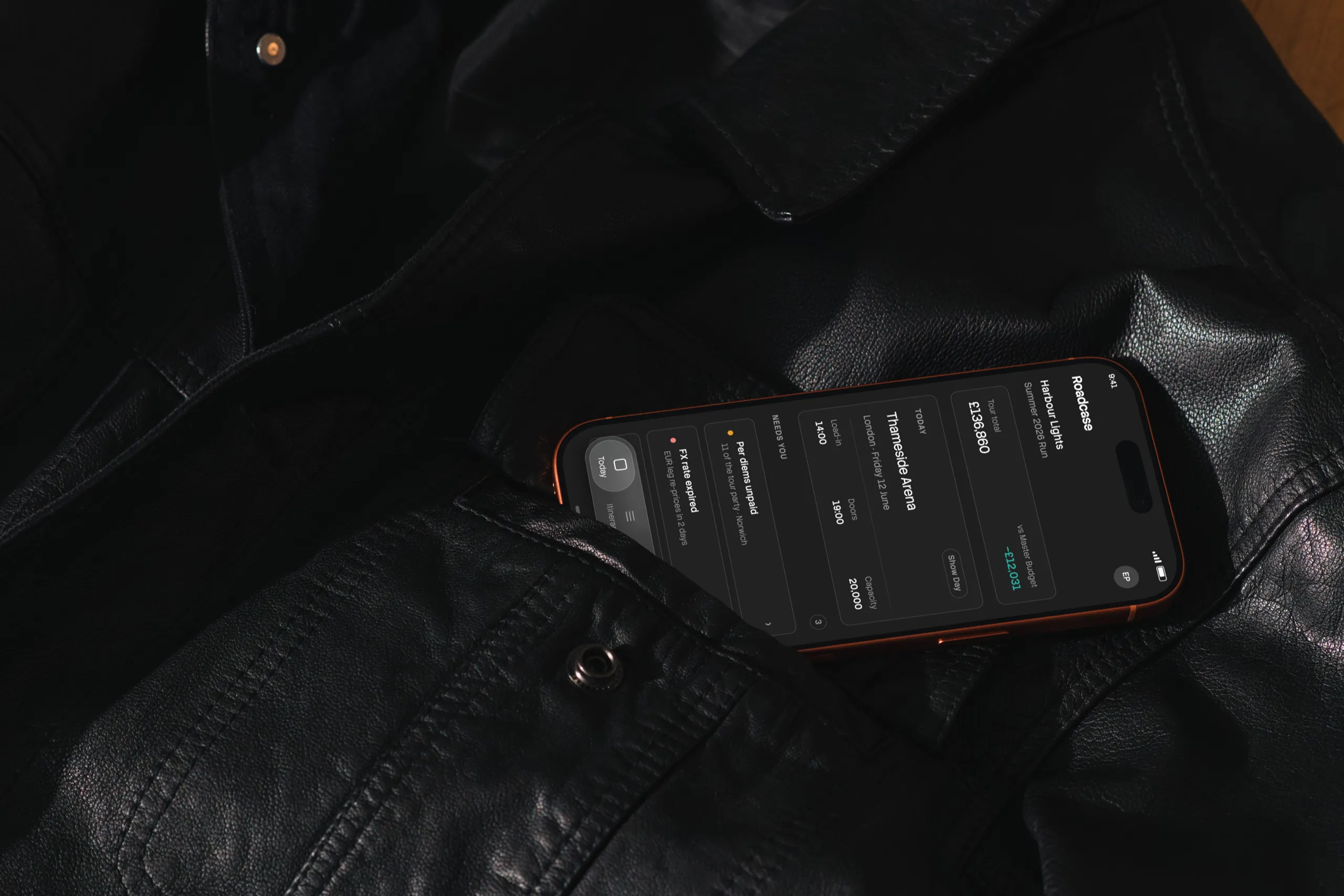 The Roadcase Today screen on an iPhone resting on a black leather jacket
