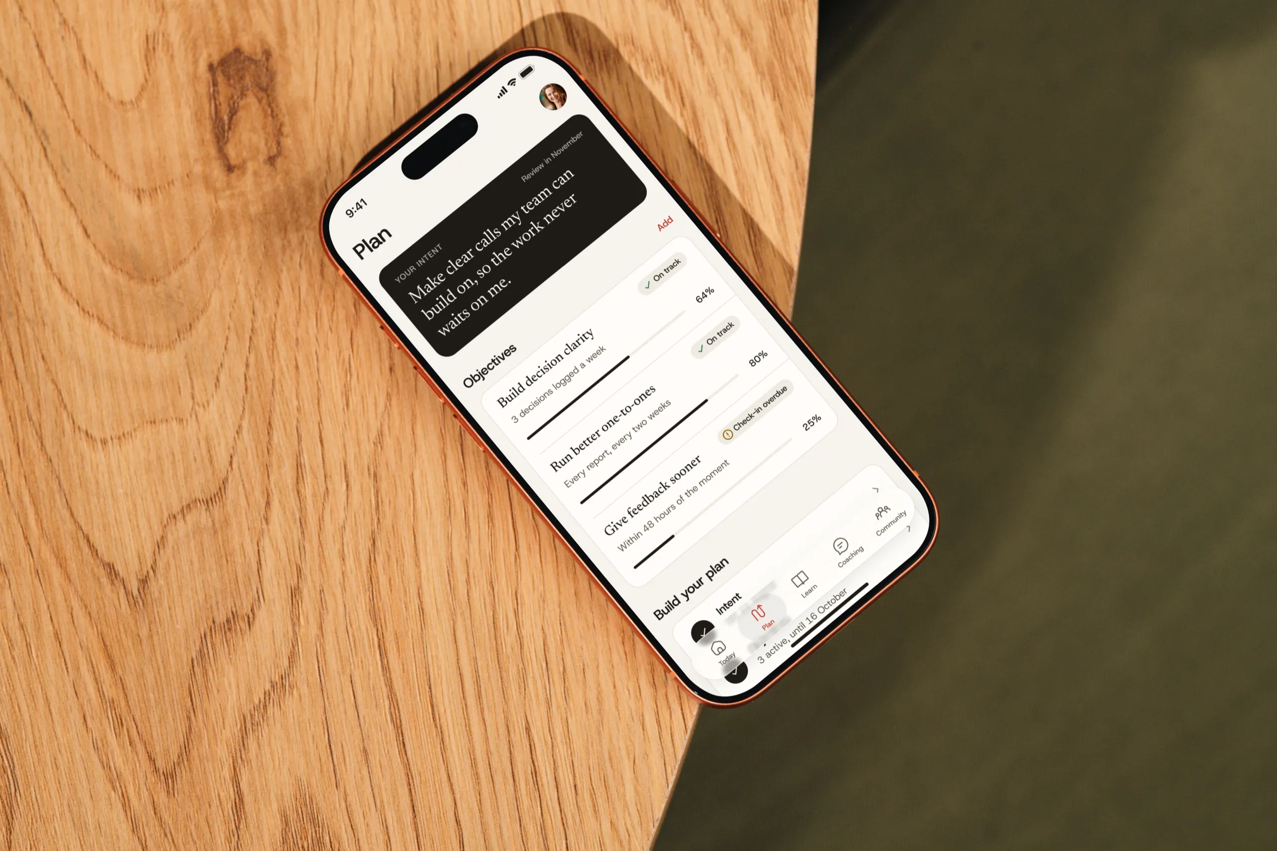 The Throughline plan screen on an iPhone lying on a wooden desk