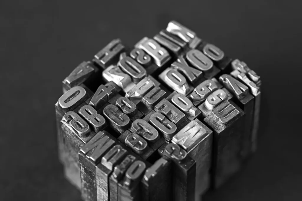 A block of metal letterpress type, in black and white